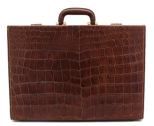 An English Vintage Brown Alligator Suitcase Height 7 x width 18 1/4 x length 12 3/4 inches.