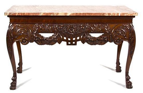 An Irish Chippendale Style Carved Mahogany Center Table Height 34 x width 55 x depth 25 1/2 inches.