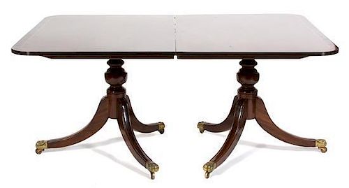 A Regency Style Mahogany Double Pedestal Extension Table Height 28 1/2 x width 48 x length 66 inches (without leaves).