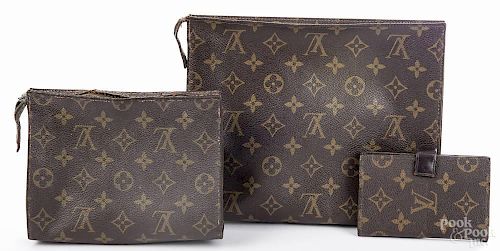 Two Louis Vuitton monogrammed clutches, 8'' h., 9 1/2'' w. and 5 1/2'' h., 7'' w.
