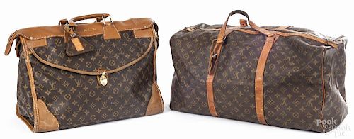 Three Louis Vuitton monogrammed luggage bags.