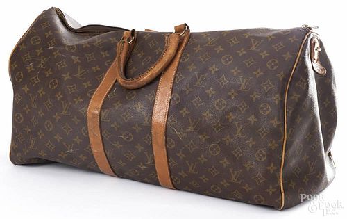 Louis Vuitton monogrammed luggage bag.