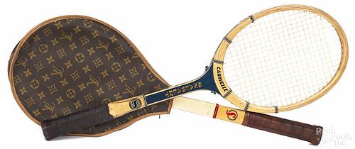 Louis Vuitton mongrammed racket cover, together with two early rackets by Spaulding and Snauwaert.