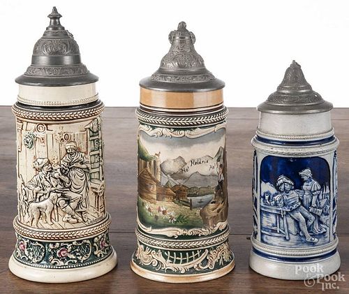 Three German pottery steins, early 20th c., 10'' h., 9 1/4'' h. and 8'' h.