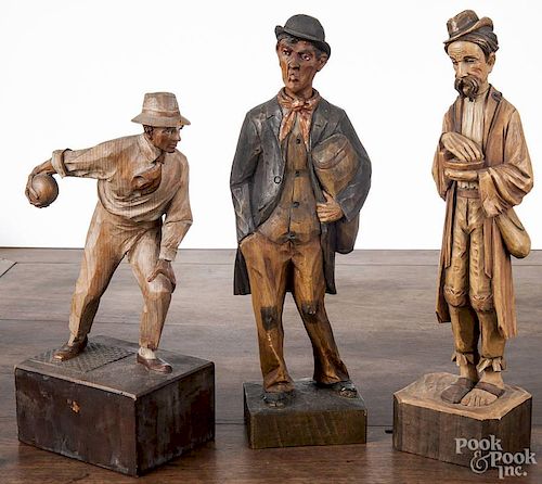 German clockwork whistler, 11 1/4'' h., together with two other carved wood figures, 13 1/4'' h.