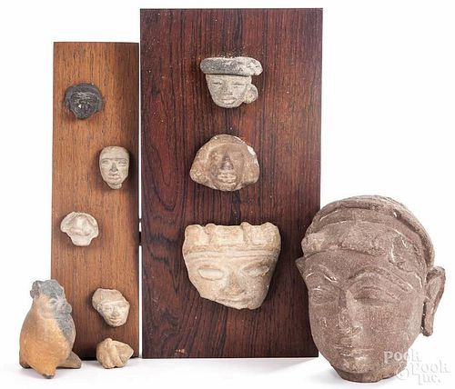 Nine pieces of South American pottery, together with a Southeast Asian carved stone Buddha head