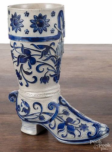 German stoneware boot, early 20th c., with relief cobalt floral decoration, 9 1/4'' h.