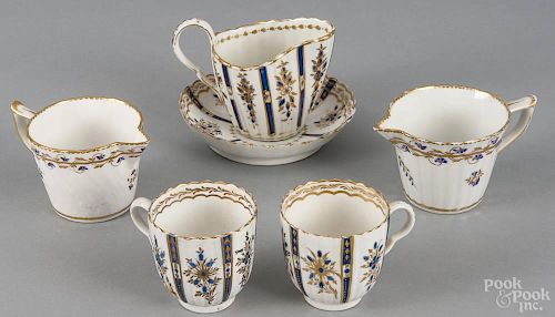 Six pieces of Crown Derby porcelain, ca. 1800, to include three creamers, two cups, and a saucer.