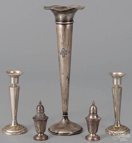 Weighted sterling silver vase, 12'' h., together with a pair of candlesticks and two shakers.