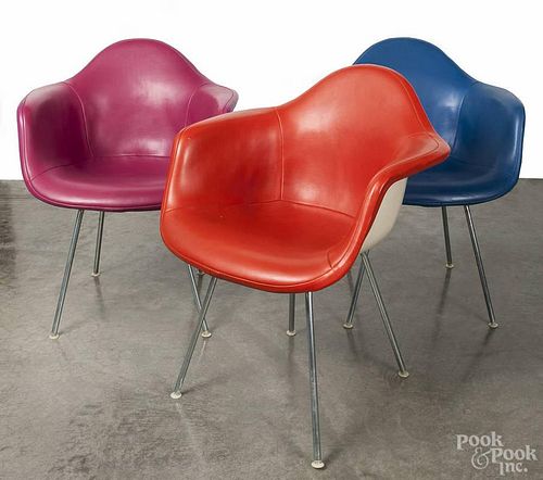 Three Herman Miller modern leather upholstered fiberglass chairs.