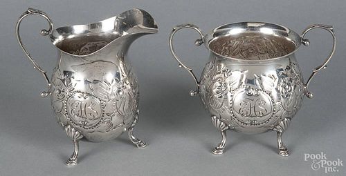 Sterling silver creamer and sugar bowl with chased floral decoration, 4 1/2'' h. and 3 3/4'' h.