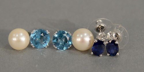 Two pairs of white gold pierced earrings, one set with blue topaz and pears, one set with blue sapphires and diamonds.
