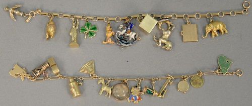 Two gold charm bracelets, each with several gold charms. 46.5 grams