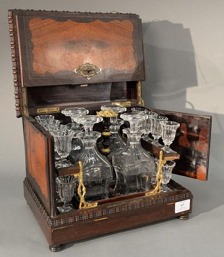 Victorian tantalus mixed wood and brass inlaid with fitted interior having four decanter bottles and a set of sixteen cordial