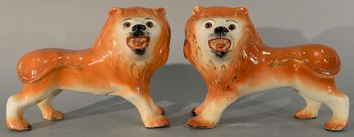 Pair of Staffordshire lions. ht. 10in., lg. 13 1/2in.