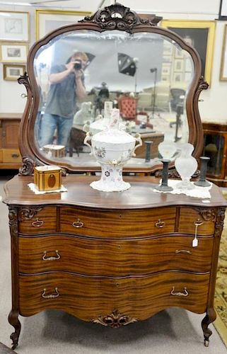 Mahogany chest and mirror with serpentine front. ht. 77in., wd. 52in. Provenance: Property from the Estate of Frank Perrotti