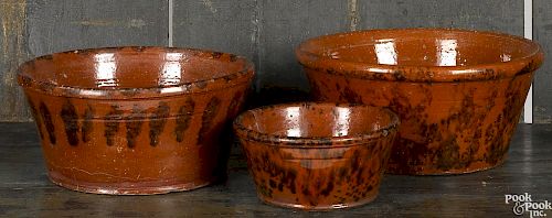 Three Pennsylvania redware mixing bowls ,19th c.