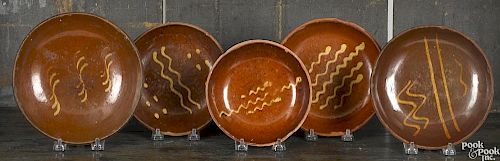 Five Pennsylvania redware plates, 19th c.
