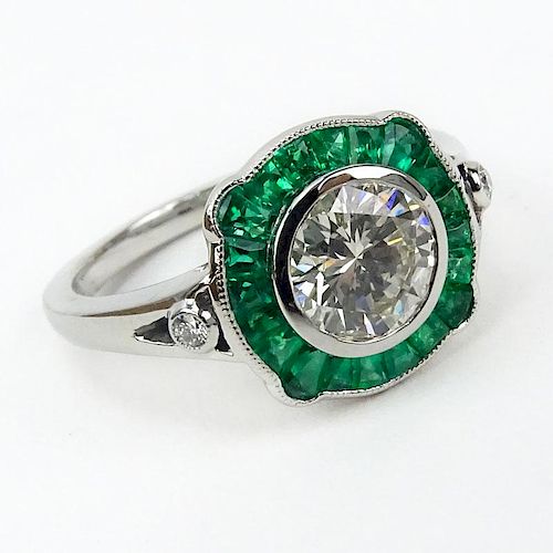 1.10 Carat Round Brilliant Cut Diamond, .63 Carat Calibre Cut Emerald and Platinum Ring.