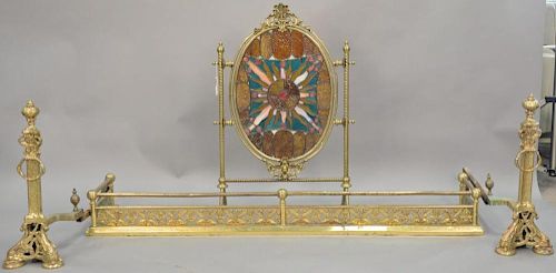 Four piece lot to include oval leaded stained glass fire screen, fire fender, and andirons with griffin bases, screen: ht. 34