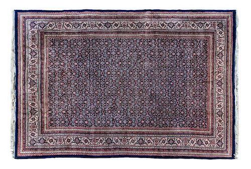 An Indo-Persian Wool Rug 8 feet 7 inches x 11 feet 4 inches.
