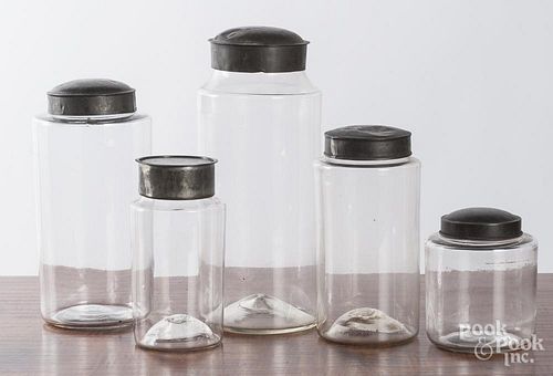 Five graduated glass country store bottles