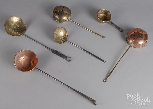 Six brass and copper cooking utensils.