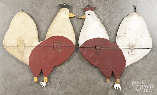 Two painted rooster trade signs.