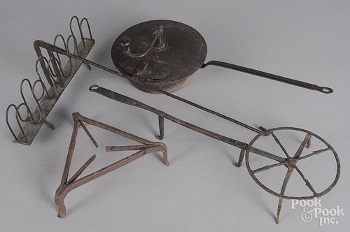 Four pieces of wrought iron hearth equipment