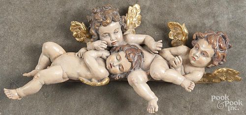 Carved and painted putti carving