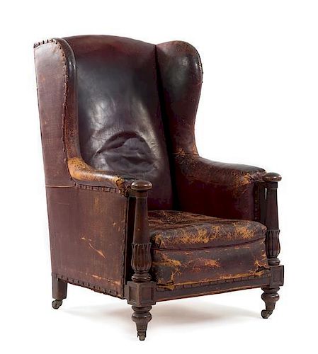 An Italian Leather-Upholstered Wingback Armchair Height 42 x width 27 x depth 32 inches.