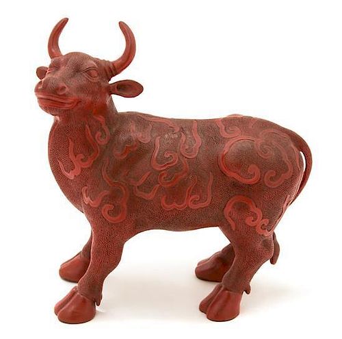 A Chinese Carved Composite Red Lacquer Model of a Bull Height 10 3/4 inches.