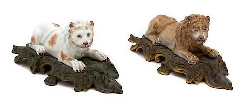 A Pair of German Porcelain Recumbent Lions Mounted on Bronze Bases Width 10 inches.