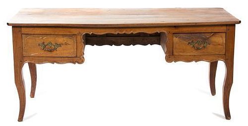 A French Provincial Carved Fruitwood Desk Height 28 1/2 x width 64 x depth 27 inches.