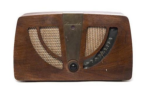 A Charles and Ray Eames Walnut Radio, American (1907-1978), (1912-1988), for Zenith, Width 13 1/2 inches.