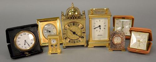 Group of eight clocks including Haller Carriage clock, Van Cleef & Arpels hardstone desk clock, Westclox travel clock, Phinne