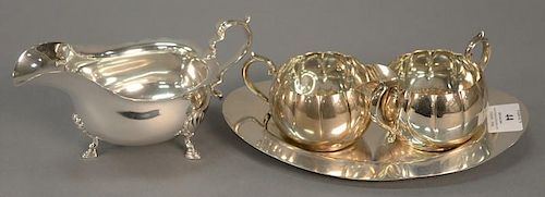 Four piece sterling silver lot to include sugar, creamer, tray, and gravy boat. 23.28 t oz.