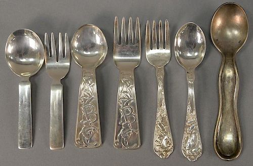 Seven piece lot of silver baby spoons and forks including Cartier two piece set, Tiffany ABC two piece set, Reed and Barton t