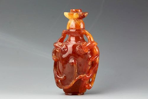 Chinese carved Cornelian snuff bottle with matching stopper. Open and deep relief carving of two foliage . 19th century