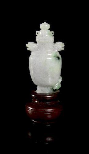 A Carved Jadeite Snuff Bottle, Height of bottle overall 2 7/8 inches.