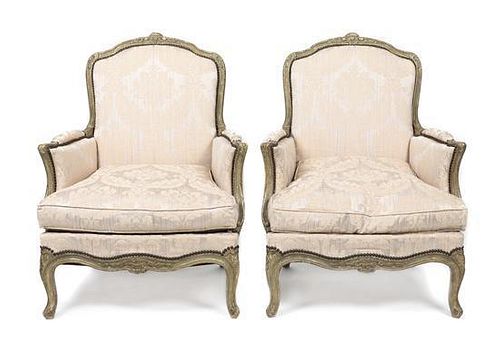 A Pair of Louis XV Style Cream Painted Bergeres, Height 37 1/2 x width 29 1/2 x depth 25 1/4 inches.