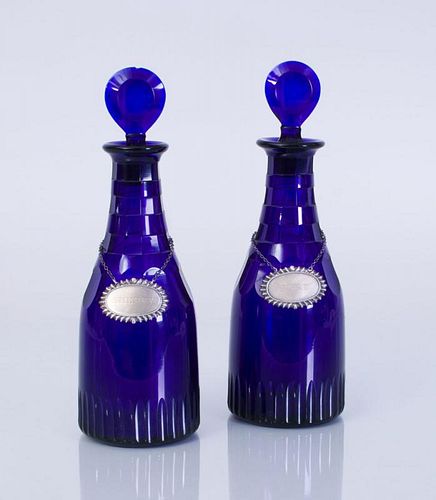 TWO ENGLISH BRISTOL BLUE GLASS DECANTERS AND STOPPERS WITH TWO AMERICAN STERLING SILVER LIQUEUR LABELS