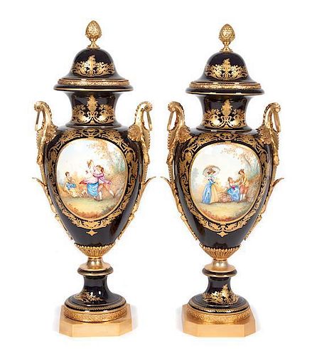 * A Pair of Sevres Gilt Bronze Mounted and Lidded Porcelain Urns Height 39 inches.
