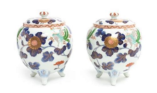 * A Pair of Japanese Style Polychrome Painted Porcelain Covered Jars Height 7 1/4 inches.