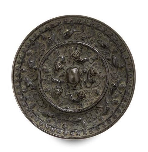 A Bronze 'Beast and Grapevine' Mirror Diameter 5 1/2 inches.