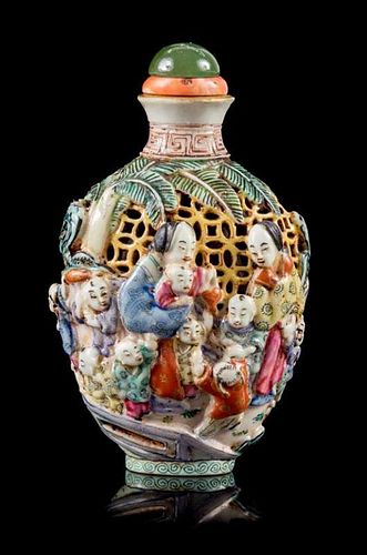 A Molded Famille Rose Porcelain Snuff Bottle Height 3 1/2 inches.
