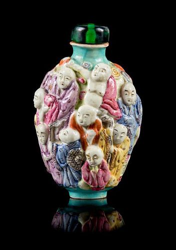 A Molded Famille Rose Porcelain Snuff Bottle Height 3 1/8 inches.