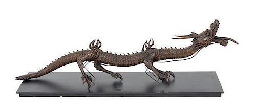 * An Articulated Wood Figure of a Dragon Length 28 inches.