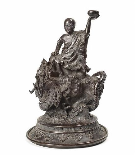 A Japanese Bronze Figure of a Luohan and Dragon, Height 10 3/8 inches.