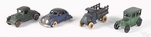 Four small cast iron vehicles